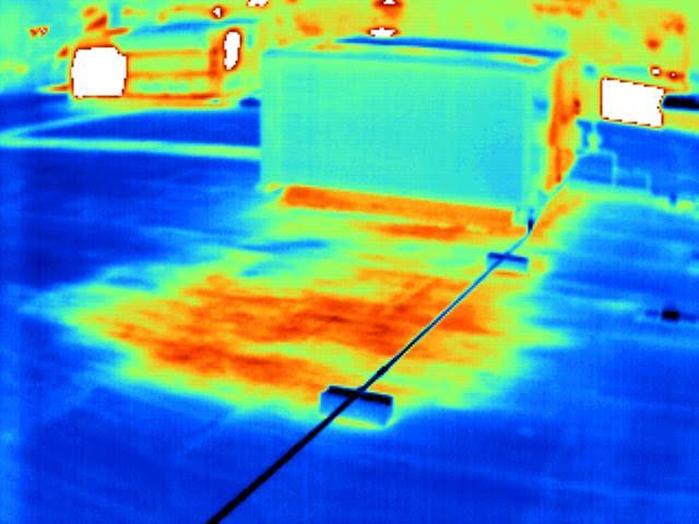 Thermal image of rooftop with heat spots.