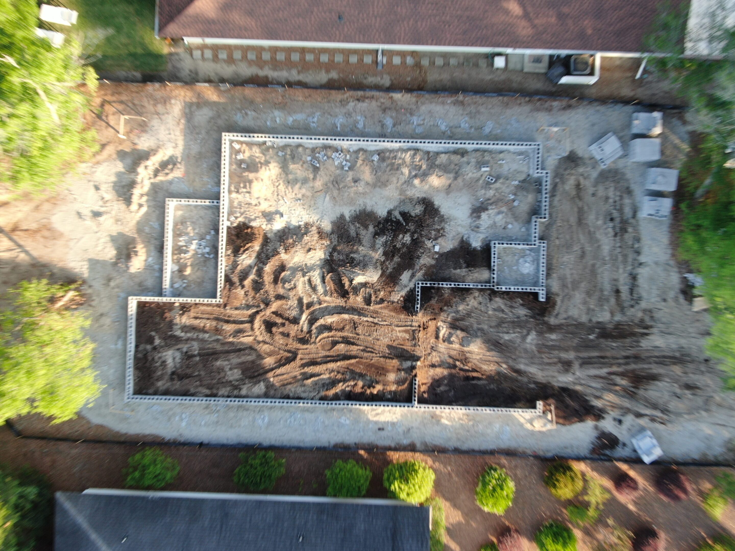Aerial view of building foundation construction site.